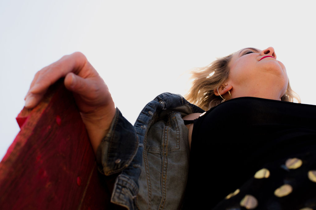 D. LeD laughing skyward against a bright open sky